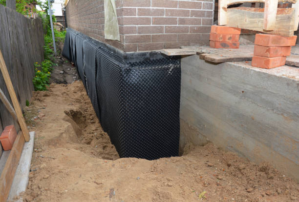 SJ Waterproofing Pros technician performing targeted Wet Basement Repair assessment in Midway, GA
